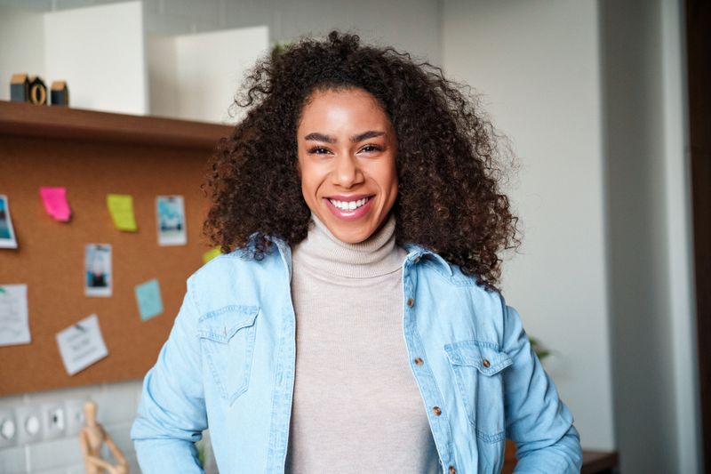 Two safety professionals shaking hands in industrial space.