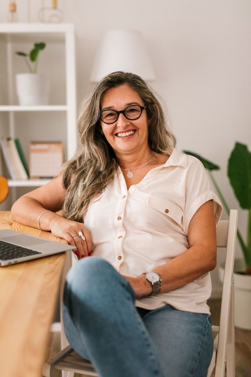 Person sitting confidently at desk with legs crossed.