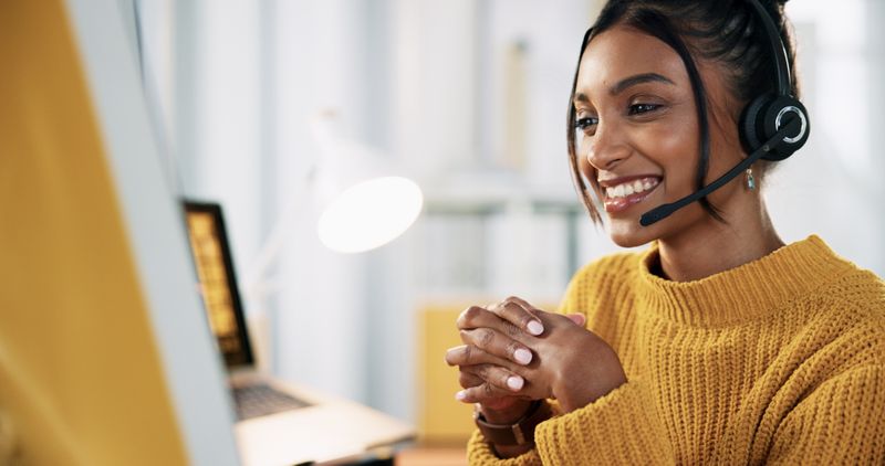 Student wearing headset looking at laptop.