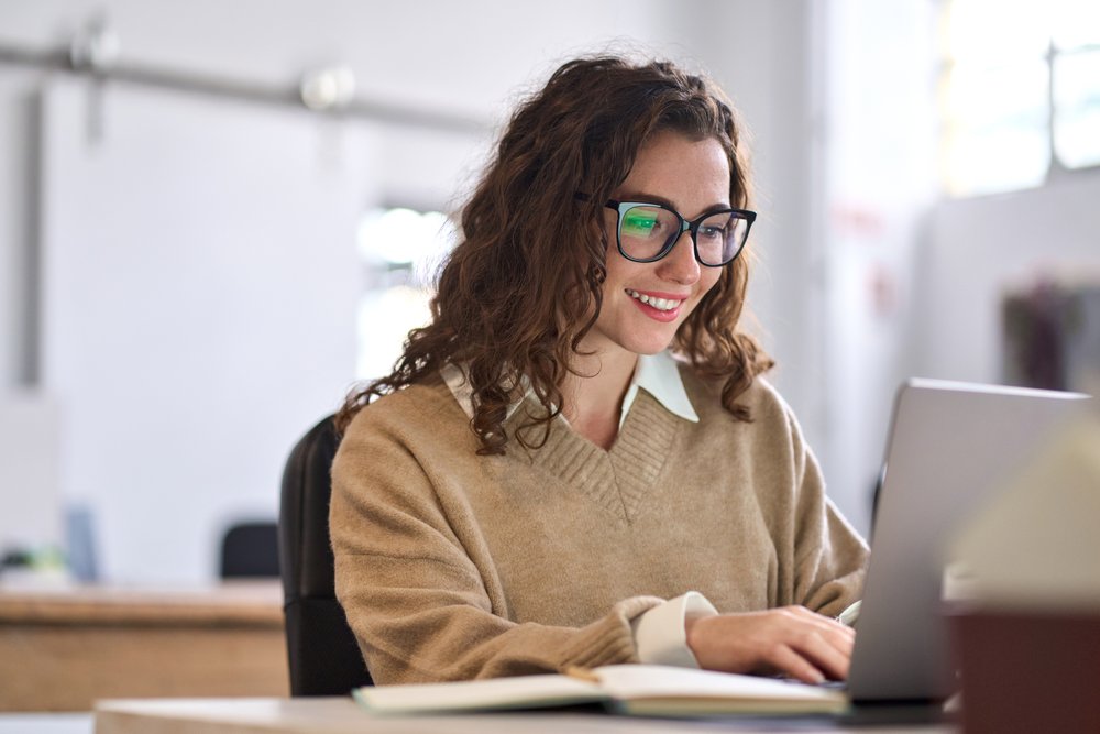 Person typing on a laptop computer.