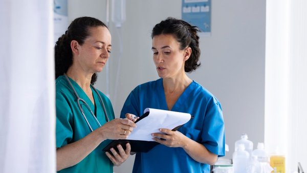 Two healthcare professionals reviewing a document together.