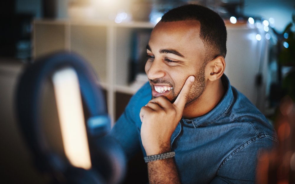 Student studying with laptop in evening.
