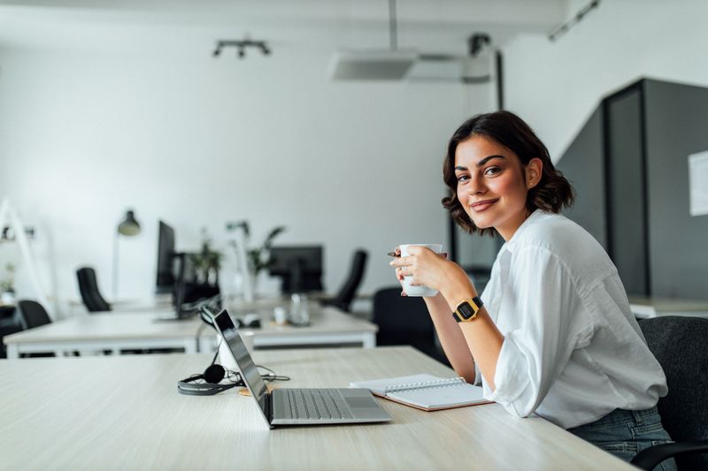 Student using a laptop in a conference room.