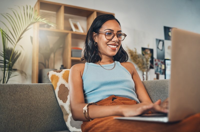 Person working on laptop from apartment couch.