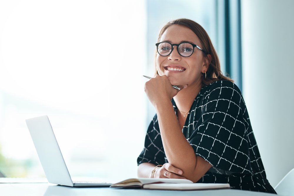 Business professional working on laptop in an office setting.