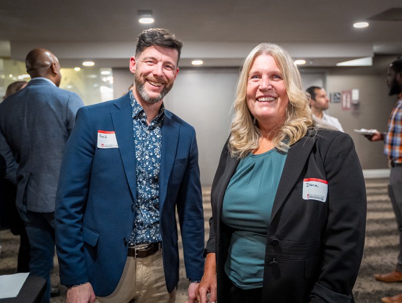UFred graduates posing together at alumni event.