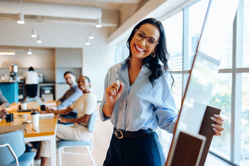 Person presenting to colleagues in a conference room.