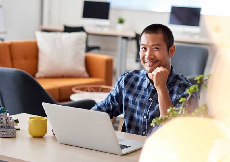 Student sitting at desk in shared office space.